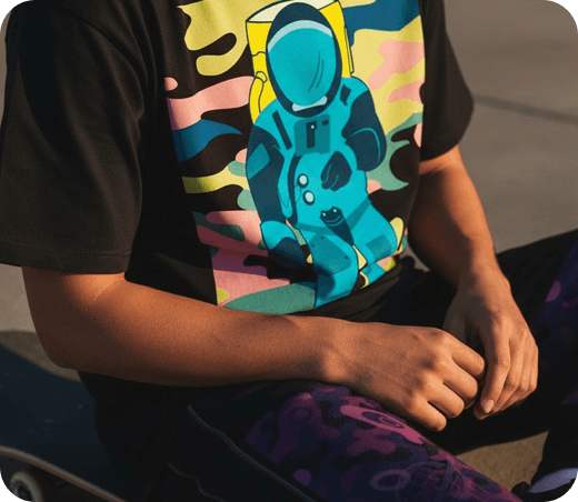 Creator wearing a colorful graphic t-shirt in a casual indoor setting.