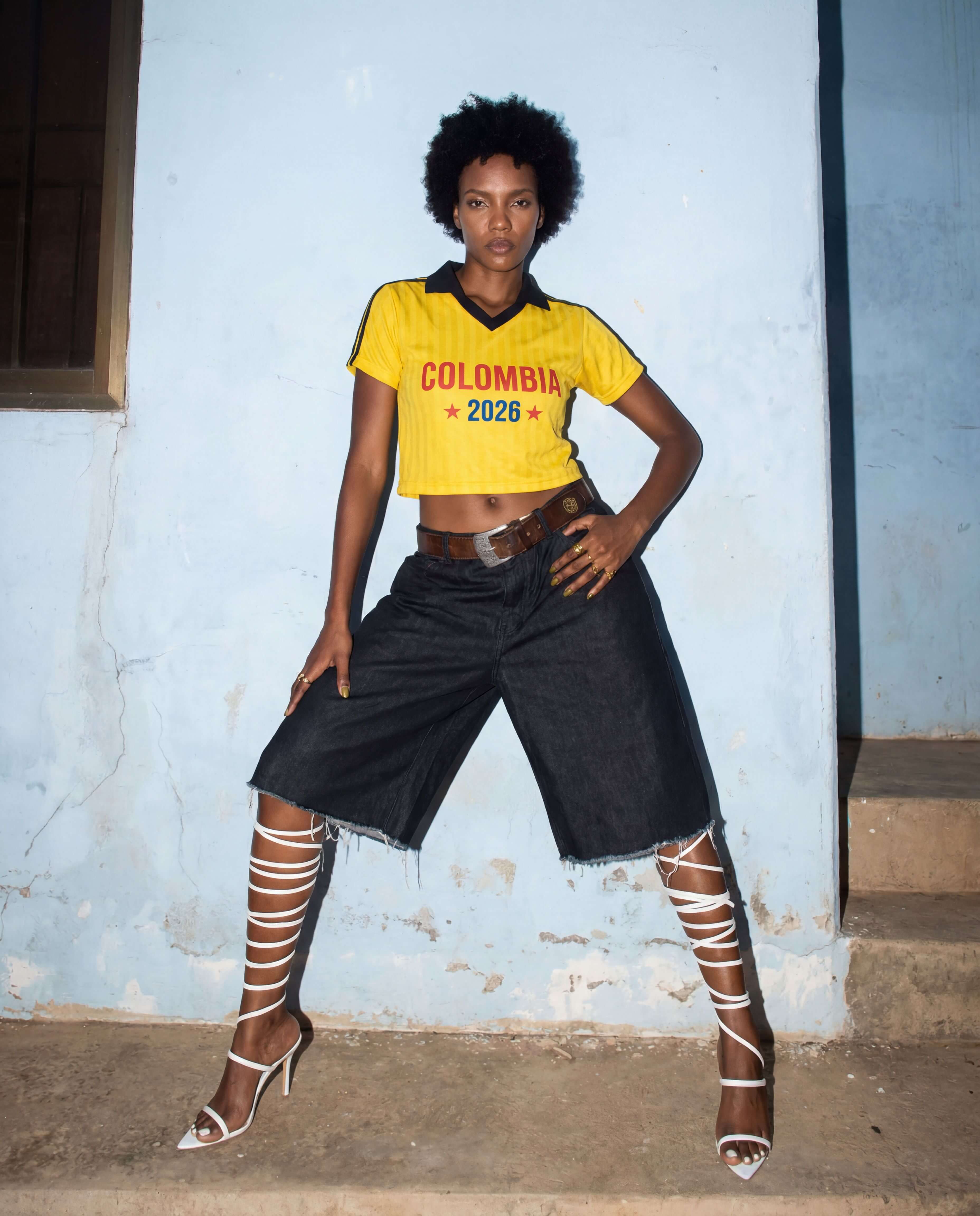Model wearing a cropped football-inspired jersey styled for everyday streetwear