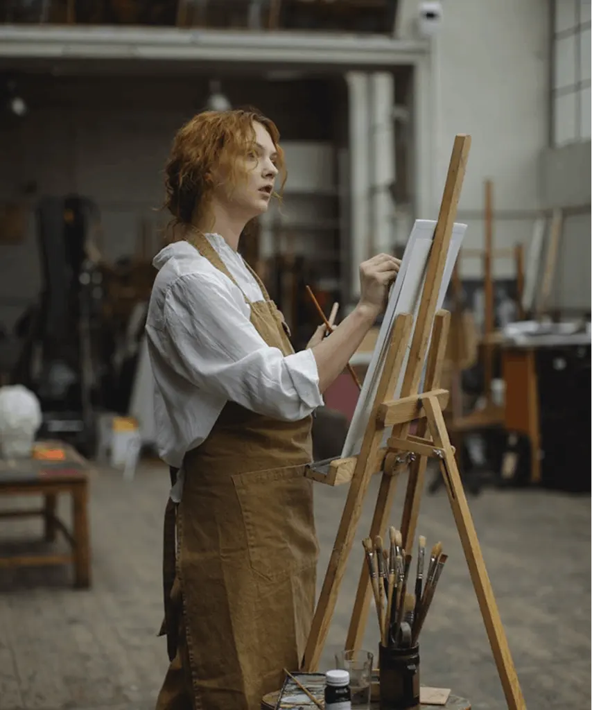 Artist painting on canvas in a creative studio environment