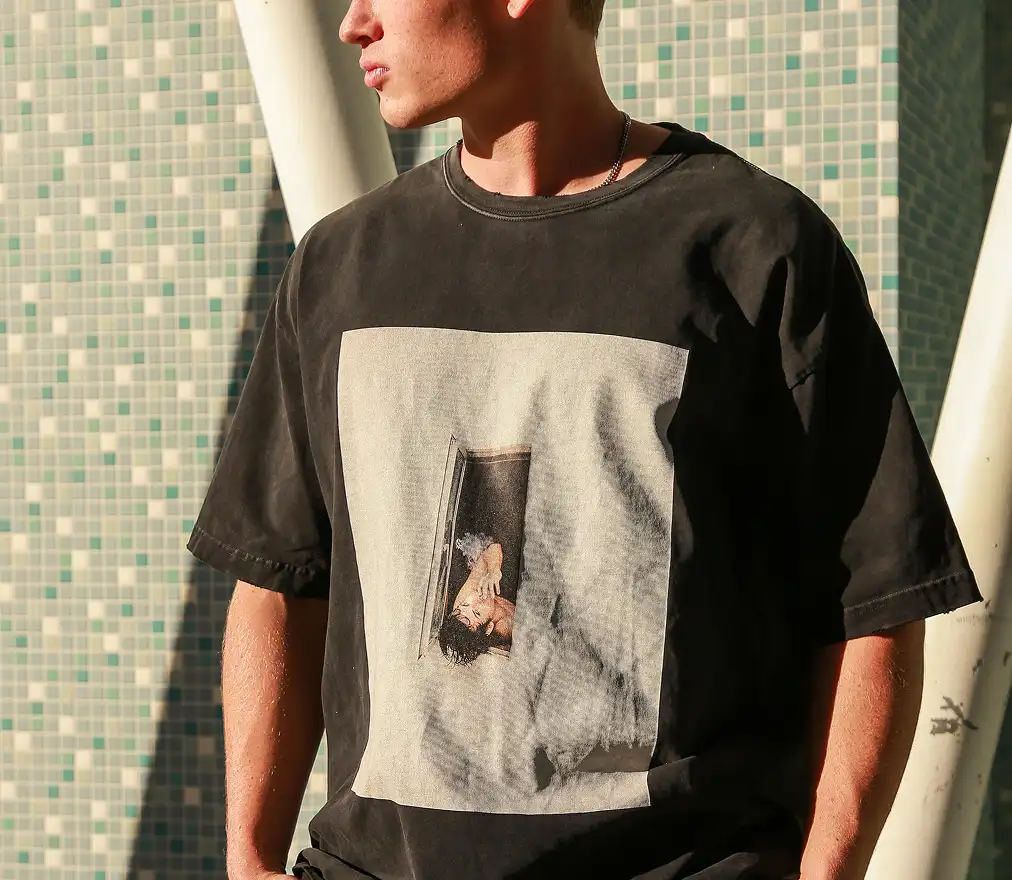 The male model is wearing the T-shirt custom-made by Tapstitch.
