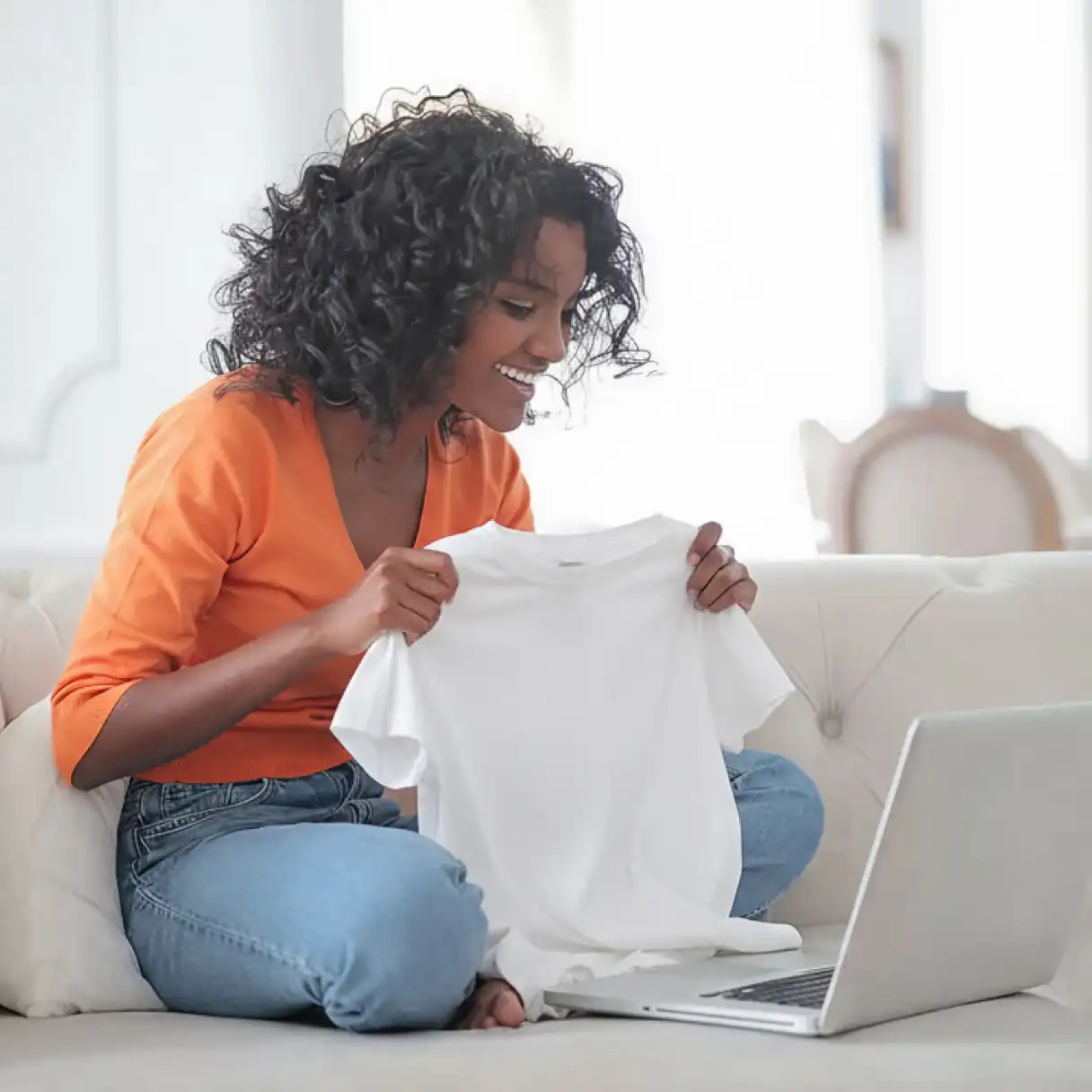 A woman is showcasing her custom T-shirt and make money on Etsy.