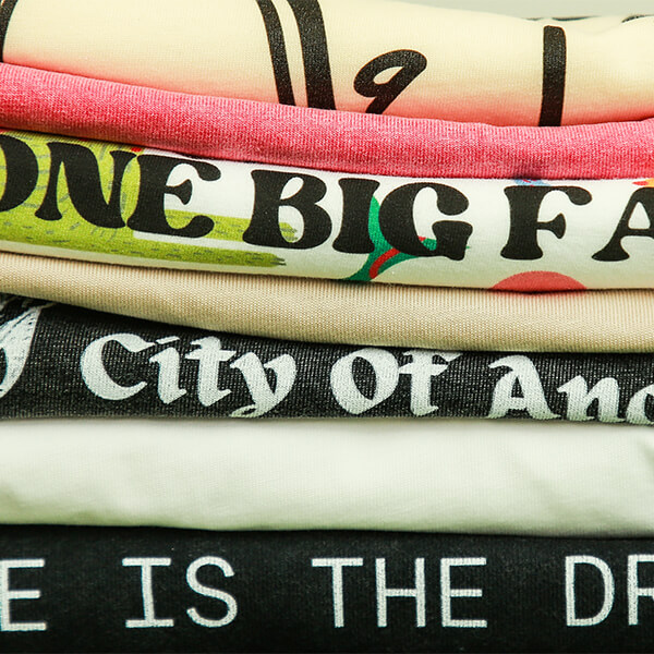 Stack of printed graphic t-shirts with custom designs