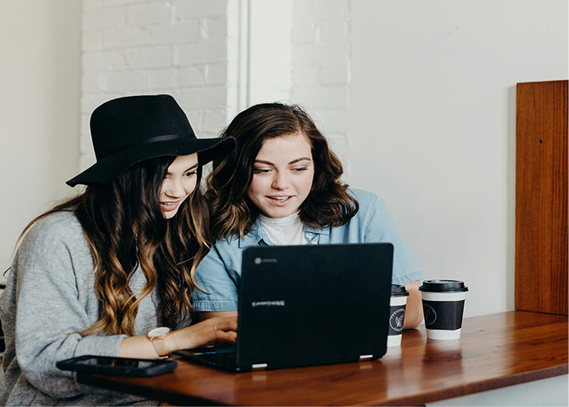 Two women planning how to start an online clothing store